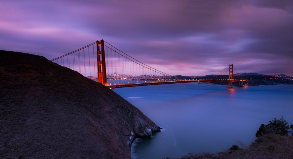 Stunning view of the Golden Gate Bridge at dusk with coastal landscape.
